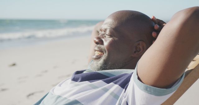 Relaxing African American Man Sunbathing on Beach - Download Free Stock Images Pikwizard.com