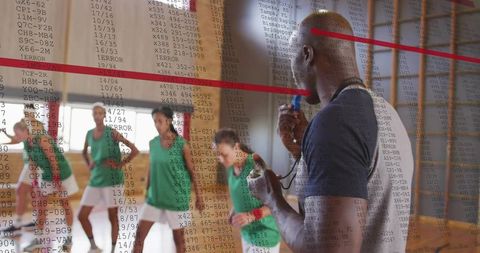 Coach coaching basketball team with whistle and clipboard during court practice, leadership