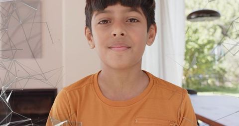 Standing Indian Boy Facing Camera in Bright Modern Living-Dining Interior