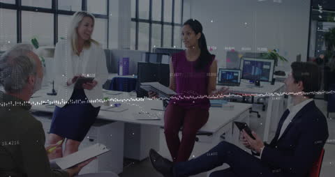 Diverse Team Analyzing Business Metrics in Modern Office