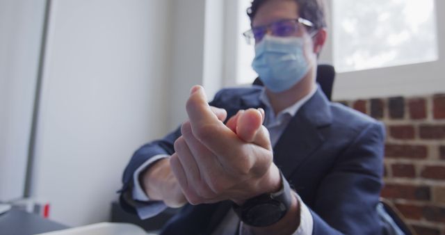 Businessman Popping Teammate Hand Gesture in Office During Daytime - Download Free Stock Images Pikwizard.com