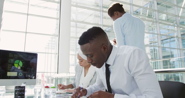 Young African American Businessman Using Tablet in Modern Sunlit Office - Download Free Stock Images Pikwizard.com