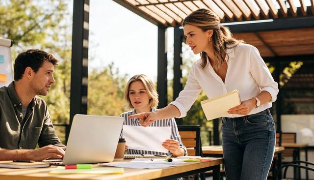 Woman team leader pointing while leading outdoor coworking brainstorming session