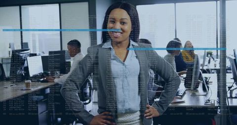 Confident businesswoman leading tech team in open-plan office with digital data overlay