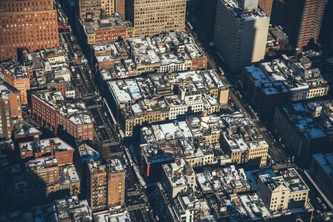 Aerial view of snow-covered city blocks in urban setting