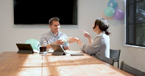 Cheerful Office Celebration with Multiracial Colleagues Sharing Cake