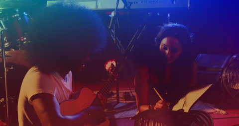 Musical Collaboration with Guitarist and Songwriter Under Colorful Lights