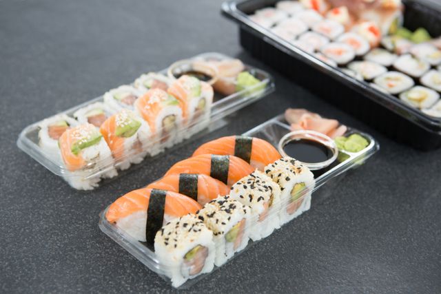 Assorted Sushi Rolls in Plastic Trays with Soy Sauce - Download Free Stock Photos Pikwizard.com