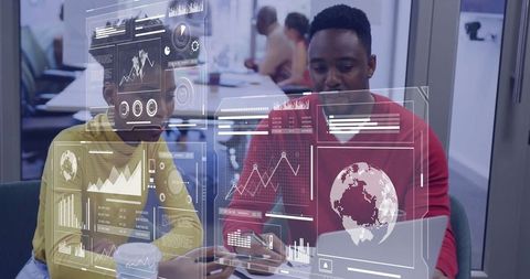 Business Colleagues Analyzing Holographic Data at Workspace