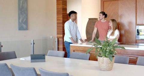 Friends Socializing in Modern Kitchen Atmosphere