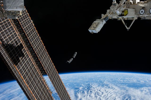 Photo showing a set of NanoRacks CubeSats being deployed by the Japanese robotic arm from the International Space Station. This image demonstrates satellite technology engineering and space research capabilities. Use this visual for education about micro-satellite deployments, space-based research technology, space exploration, engineering, and showcasing the collaboration among international space agencies.