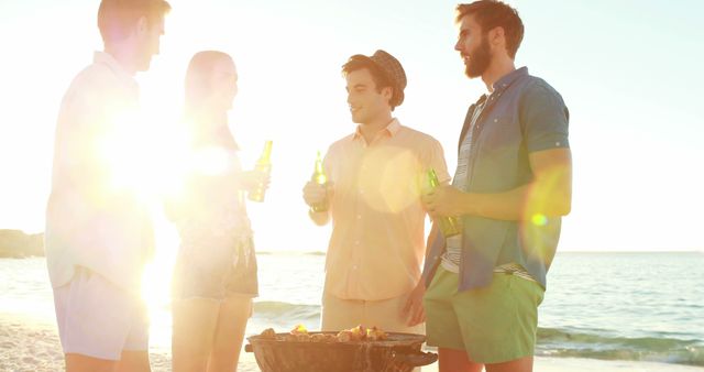 Young Adults Relaxing at Beach Barbecue During Sunset - Download Free Stock Images Pikwizard.com