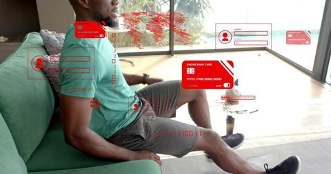Man interacting with augmented fintech overlays on sofa, logging into online banking from home