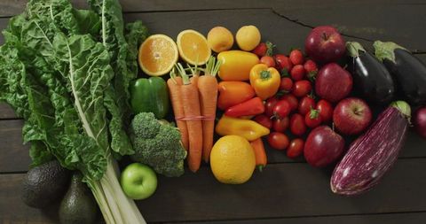 Colorful Assortment of Fresh Fruits and Vegetables on Wooden Background