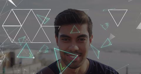 Smiling Young Man Surrounded by Digital Abstract Display