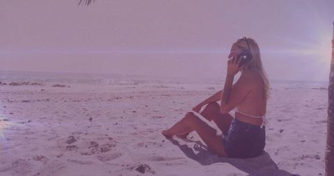 Young Woman Enjoying Beach Sunset While Talking on Smartphone