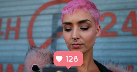 Punk woman with pink hair checking social media likes