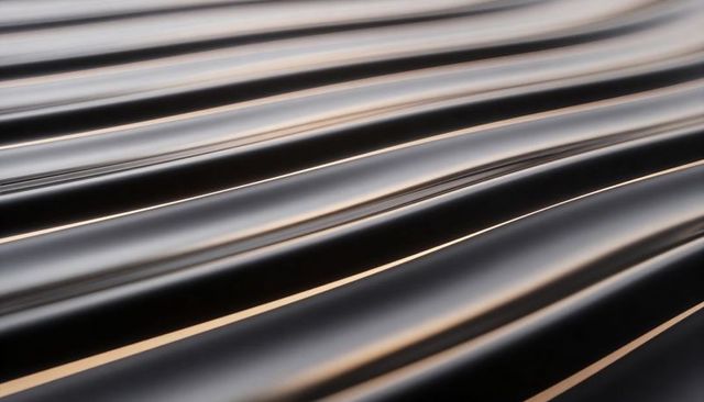 Glossy black curved ridges reflecting warm light diagonal polished metallic abstract sleek