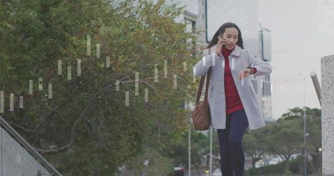 Businesswoman in motion checking time and communicating outdoor