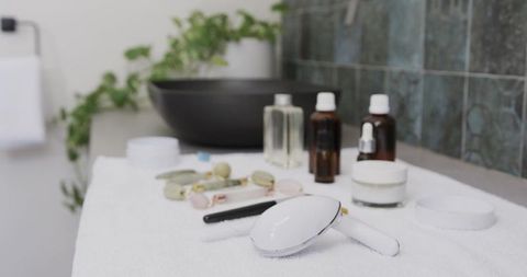 Vanity countertop featuring electric facial brush, jade rollers and amber skincare bottles