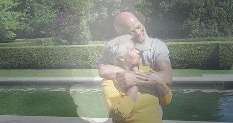 Joyful Senior Couple Embracing with Warm Sunlight