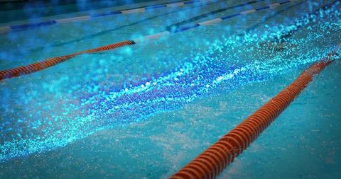 Vibrant water splash across blue swimming pool lane divider