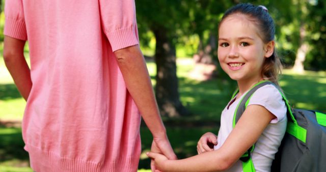 Smiling Schoolgirl with Mother on First Day of School - Download Free Stock Images Pikwizard.com