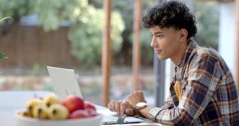 Young Professional Working on Laptop in Outdoor Home Office