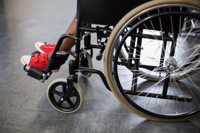 Boy sitting on wheelchair at school 