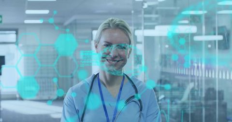 Smiling nurse wearing stethoscope using holographic medical interface in clinic