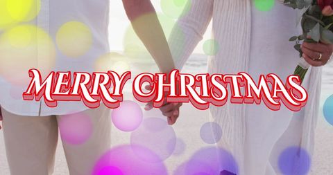 Joyful Senior Couple Holding Hands at Beach Holiday Greeting