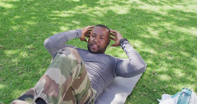 African american male soldier exercising and doing sit ups in garden - Download Free Stock Photos Pikwizard.com