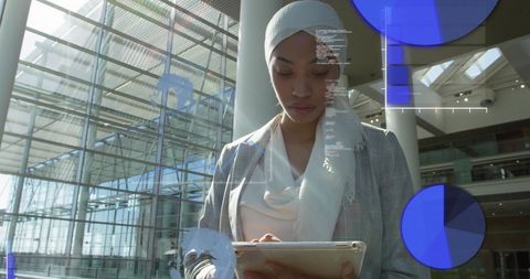 Businesswoman Analyzing Financial Data on Tablet in Modern Building