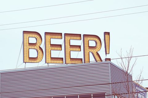 Large beer sign on brewery rooftop with vintage aesthetic