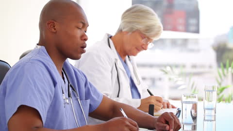 Doctors Concentrating in Bright Office Environment