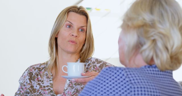 Women having serious conversation while drinking coffee - Download Free Stock Images Pikwizard.com