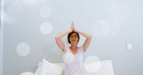 Caucasian Woman Meditating in Calming Environment with Bokeh Effect