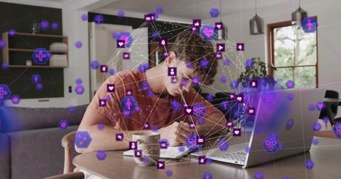 Young man working remotely at home desk with laptop and holographic network overlay