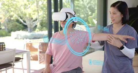 Therapist guiding patient wearing vr headset during arm rehabilitation with ar interface