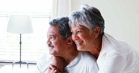 Happy Senior Couple Embracing with Joyful Smiles at Home