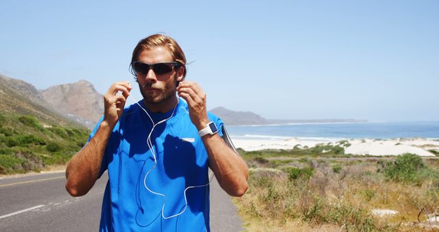 Man Preparing for Outdoor Jog Near Coastal Road - Download Free Stock Images Pikwizard.com