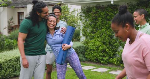 Diverse Friends Gathering Outdoors with Yoga Mats