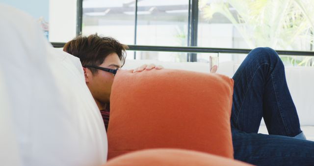 Relaxed Man Lounging on Sofa Using Smartphone - Download Free Stock Images Pikwizard.com