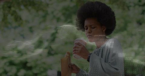 Woman Enjoying Coffee and Snack Outdoors in Park