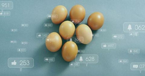 Brown eggs clustering with social media notification overlays on matte blue surface