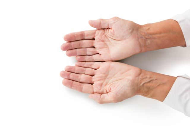 Senior hands with open palms facing up on a white background. Ideal for use in healthcare, aging, and support-related materials. Can be used to symbolize caregiving, human connection, and the passage of time.