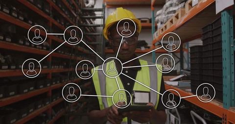 Warehouse worker using tablet for inventory management with network icons