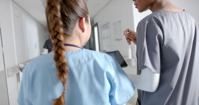 Diverse Female Doctors Collaborating Using Tablet in Hospital Corridor - Download Free Stock Images Pikwizard.com