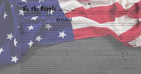 Draped american flag over constitution parchment featuring 'we the people' calligraphy