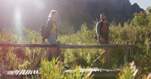 Couple Hiking on Wooden Bridge Amidst Mountain Landscape - Download Free Stock Images Pikwizard.com